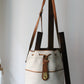 Sac à main Lancel modèle seau en cuir blanc et marron
