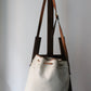 Sac à main Lancel modèle seau en cuir blanc et marron