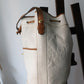Sac à main Lancel modèle seau en cuir blanc et marron