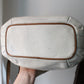 Sac à main Lancel modèle seau en cuir blanc et marron