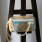 Louis Vuitton pochette Volga en PVC embossé Prism Monogram
