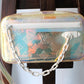 Louis Vuitton pochette Volga en PVC embossé Prism Monogram