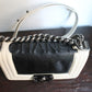 Chanel sac à main modèle Boy 20 cm en veau glacé noir et ivoire