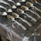 12 silver mocha spoons with flower decorations dating from 1916